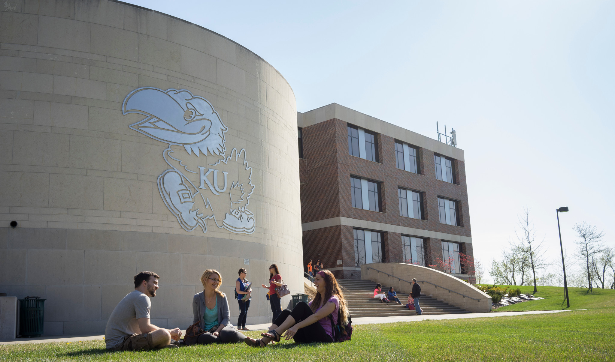 People sitting in front of buildings at the KU Edwards Campus
