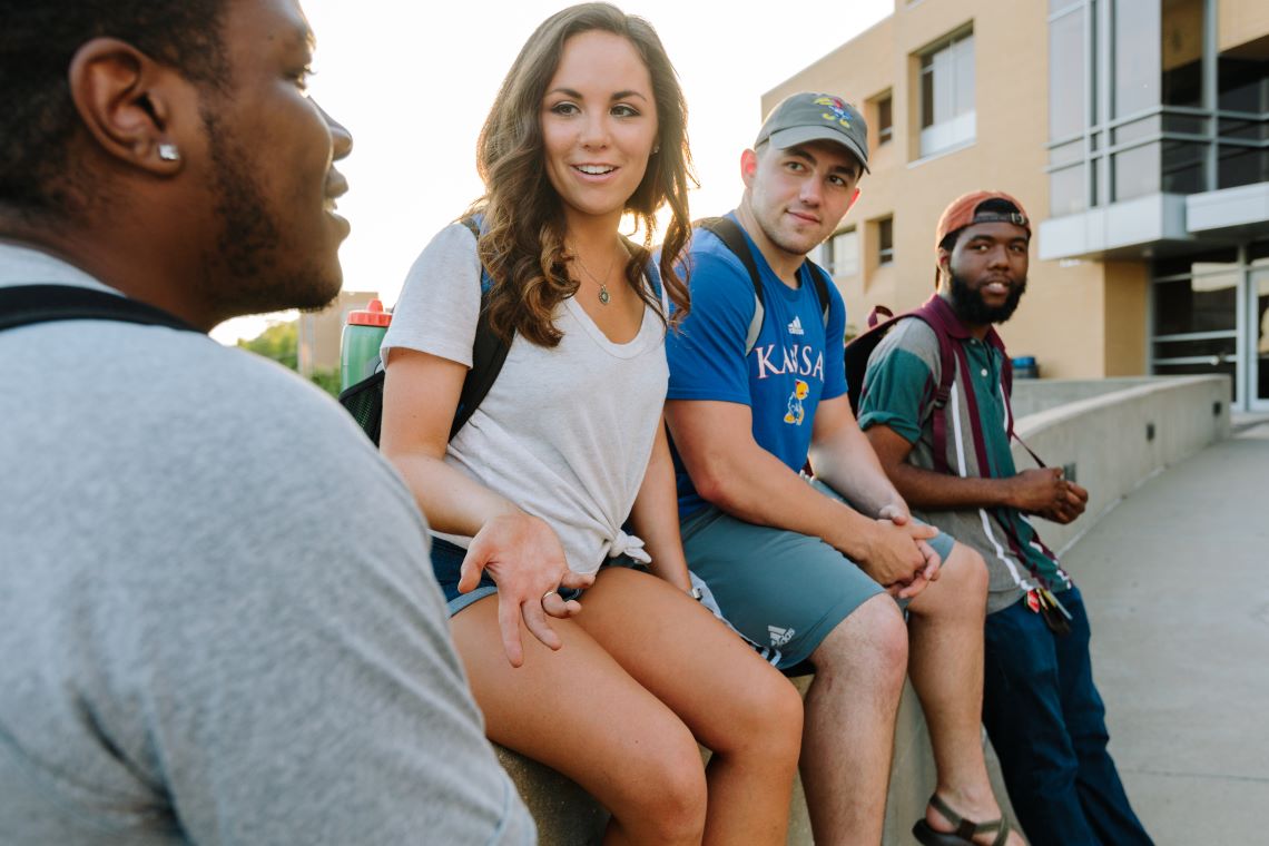 Students in small group sitting outside